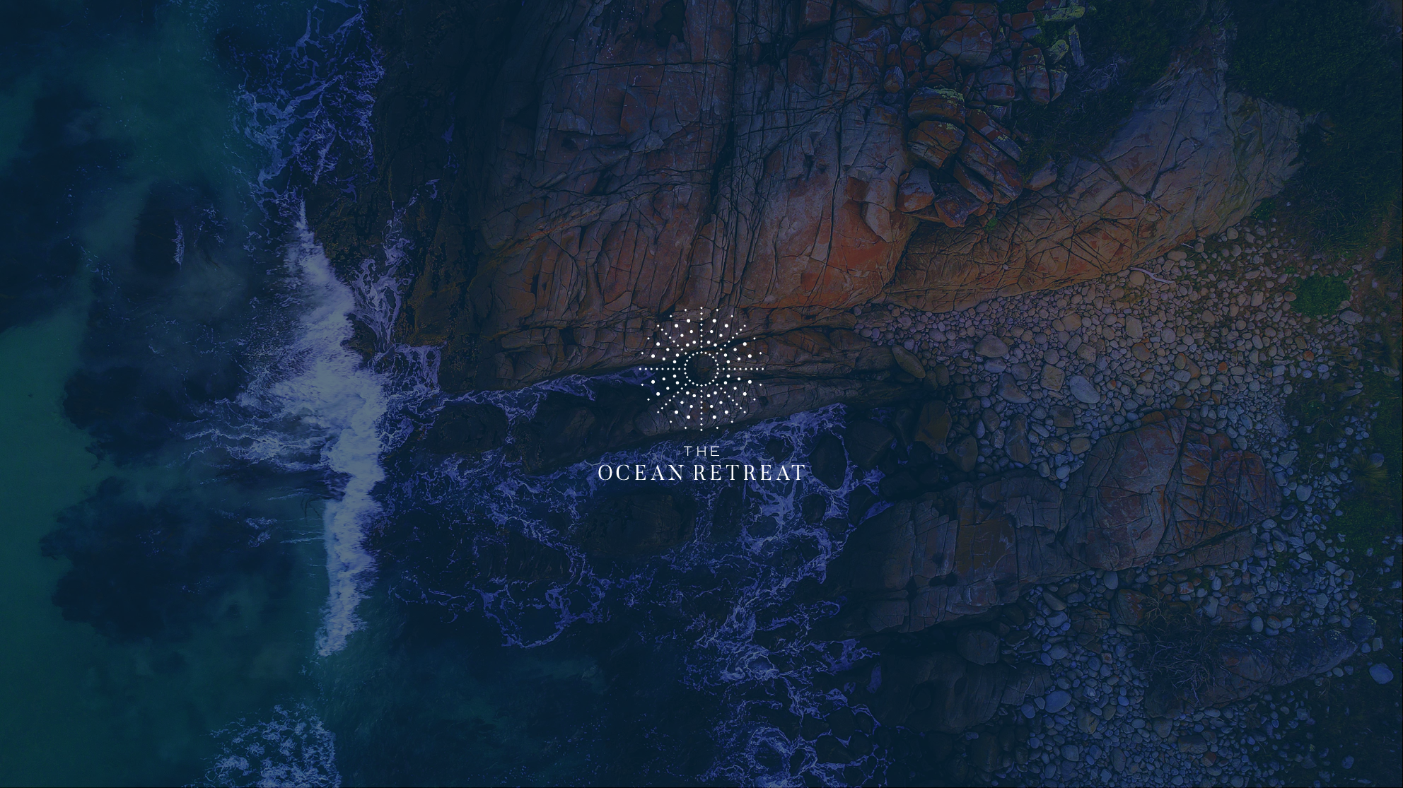 The Ocean Retreat logo overlaid over photo of rocks and ocean with waves